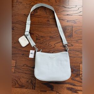 Kate Spade light blue pebble leather crossbody with striped strap.
